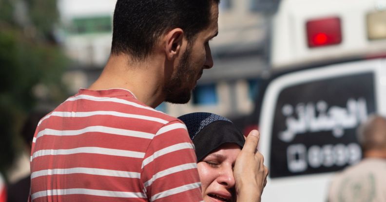 A person comforting a loved one in the Gaza Strip