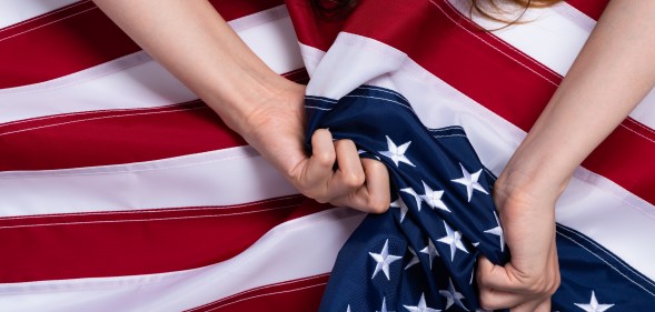 Woman holding US flag.