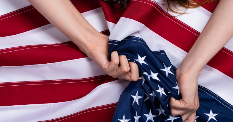 Woman holding US flag.