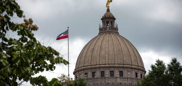 The state flag flies over the Mississippi State Capitol building in Jackson, Mississippi on June 29, 2020.