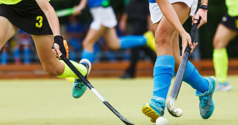 A close-up of a field hockey game.