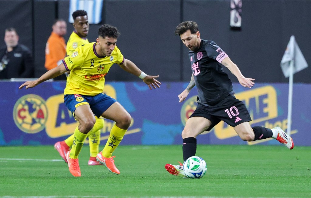 Lionel Messi #10 of Inter Miami CF kicks the ball under pressure from Sebastian Caceres #4 of America in the first half of their preseason friendly match.