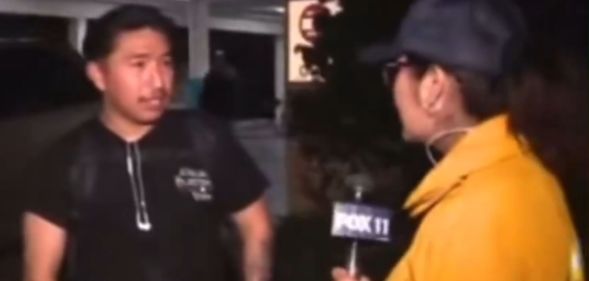 A screenshot of a man speaking to a news reporter in a yellow jacket.