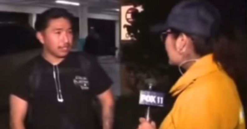 A screenshot of a man speaking to a news reporter in a yellow jacket.