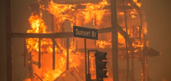 Image of a road sign reading "Sunset Boulevard" seen during devastating wildfires in LA, California