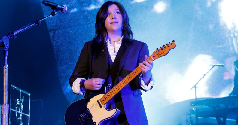 Musician Lucy Dacus performs on stage with an electric guitar