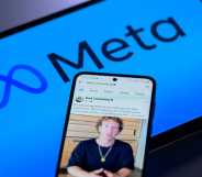 An image showing a screen with Meta's logo on it and a phone on top of it with an image of its founder, Mark Zuckerberg.