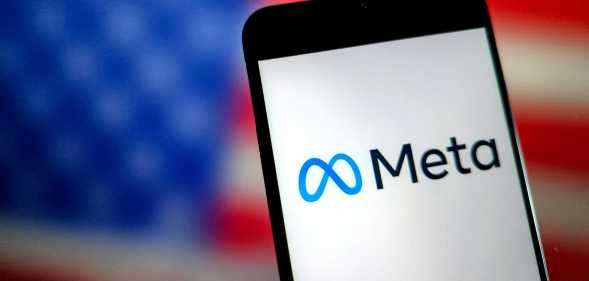 An illustration photo shows the Meta LOGO displayed on a smartphone, an American flag is behind it