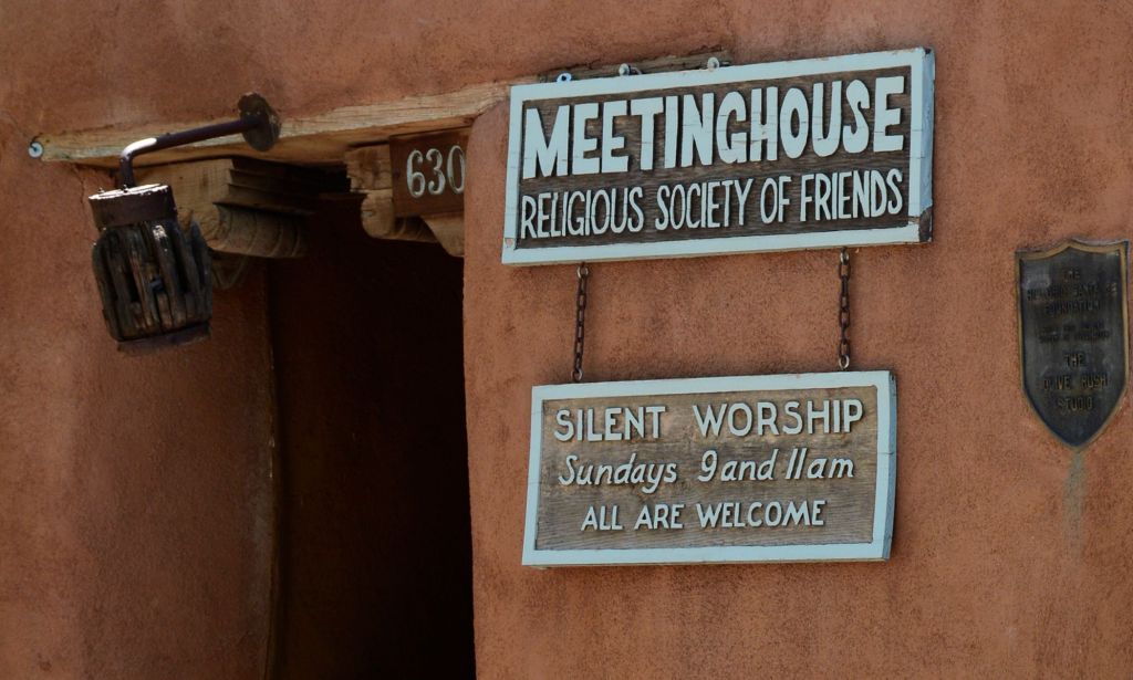 A Quakers sign reading "Meeting House Religious Society of Friends. Silent Worship, Sundays 9 and 11am, ALL ARE WELCOME."