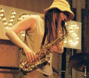 A person playing the saxophone on stage.