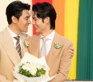 Thai actors Apiwat "Porsch" Apiwatsayree (L) and Sappanyoo "Arm" Panatkool pose for pictures after registering their same-sex marriage at the Phra Nakhon district office in Bangkok on January 23, 2025