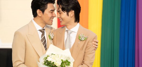 Thai actors Apiwat "Porsch" Apiwatsayree (L) and Sappanyoo "Arm" Panatkool pose for pictures after registering their same-sex marriage at the Phra Nakhon district office in Bangkok on January 23, 2025