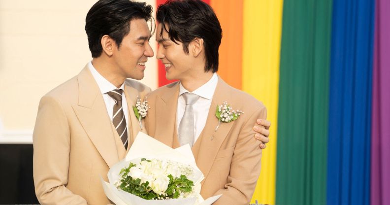 Thai actors Apiwat "Porsch" Apiwatsayree (L) and Sappanyoo "Arm" Panatkool pose for pictures after registering their same-sex marriage at the Phra Nakhon district office in Bangkok on January 23, 2025