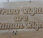 A sand mural that reads: "Trans Rights are Human Rights."