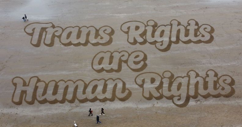 A sand mural that reads: "Trans Rights are Human Rights."