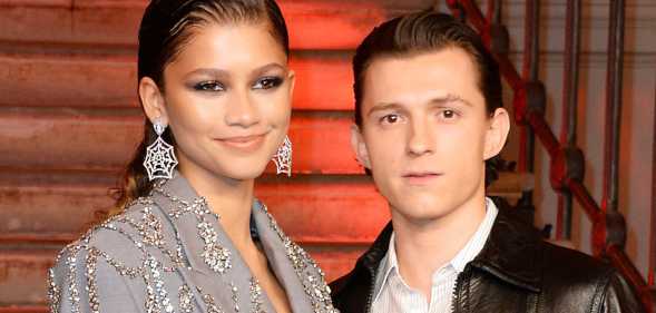 Zendaya and Tom Holland pose at a photocall for 'Spider-Man: No Way Home'.