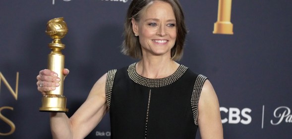 Jodie Foster holding a Golden Globe award