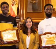 Ibrahima Diack and Magatte N'Diaye stand beside Mayor Inés Rey after being honoured by Spanish city A Coruña