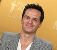 Andrew Scott in a grey suit and white shirt smiling on the SAG Awards 2025 red carpet.