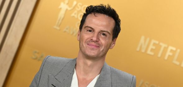 Andrew Scott in a grey suit and white shirt smiling on the SAG Awards 2025 red carpet.