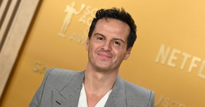 Andrew Scott in a grey suit and white shirt smiling on the SAG Awards 2025 red carpet.