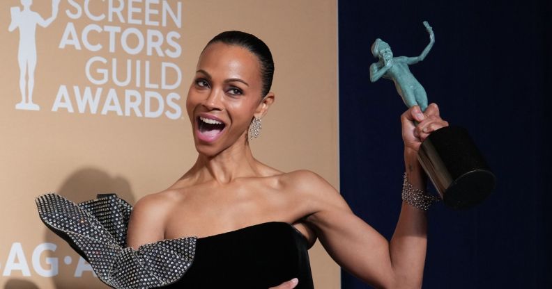 Emilia Pérez star Zoë Saldaña beams and holds up her award after winning the Best Supporting Actress SAG Award.