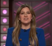 Kelly Clarkson addressing the camera on her talk show, wearing a blue jumper.