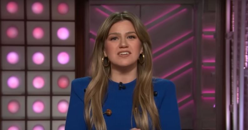 Kelly Clarkson addressing the camera on her talk show, wearing a blue jumper.