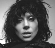 Lady Gaga in a black wig, her face close to the camera, in black and white for the cover of her album Mayhem.