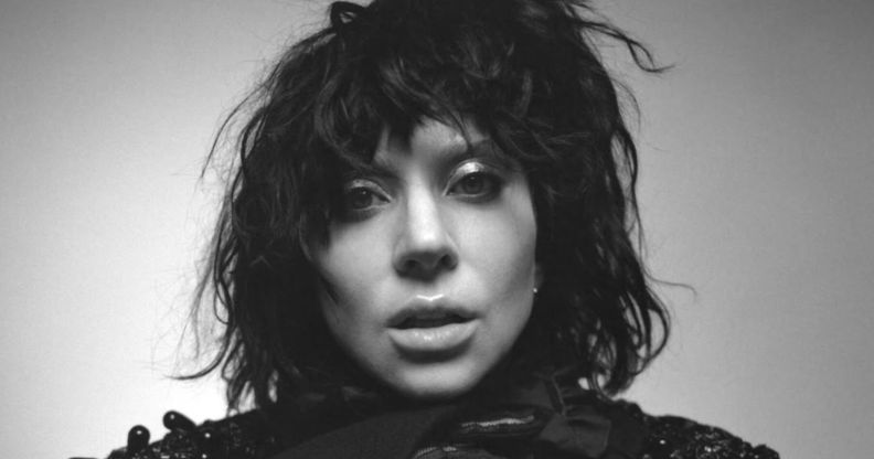 Lady Gaga in a black wig, her face close to the camera, in black and white for the cover of her album Mayhem.