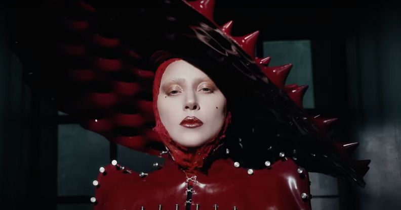 Lady Gaga in a red spiked latex hat in the music video for new single 'Abracadabra'.