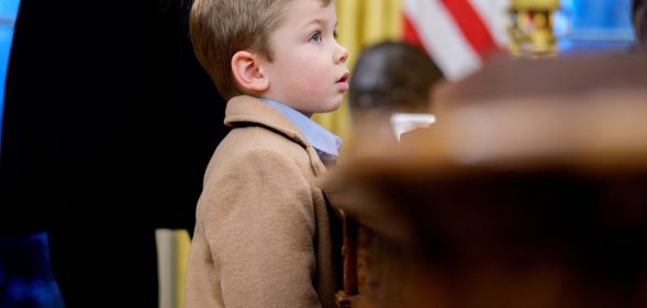 Elon Musk's son, X, standing next to Donald Trump.