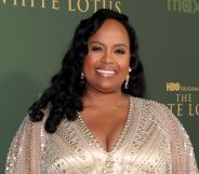 Natasha Rothwell in a matte dress smiling at the premiere of The White Lotus season three