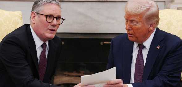 UK Prime Minister Sir Keir Starmer hands an invitation from King Charles III for a second state visit to US President Donald Trump.