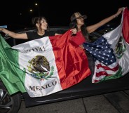 Two women holding Mexican flags at L.A protests against Trump immigration policies