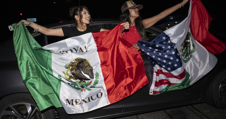 Two women holding Mexican flags at L.A protests against Trump immigration policies