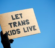 A sign reading "Let Trans Kids Live" in a protest for gender-affirming care