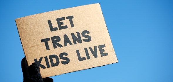 A sign reading "Let Trans Kids Live" in a protest for gender-affirming care