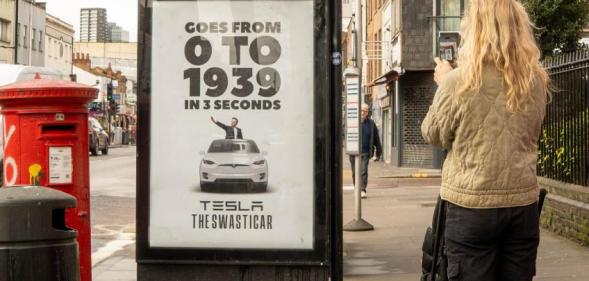 A poster at a London bus stop reading "0 to 1939" and featuring a graphic of the Tesla boss appearing to give a Nazi Salute