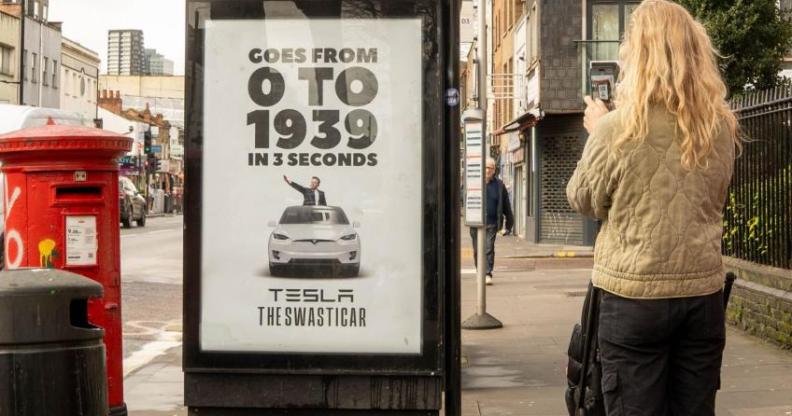 A poster at a London bus stop reading "0 to 1939" and featuring a graphic of the Tesla boss appearing to give a Nazi Salute