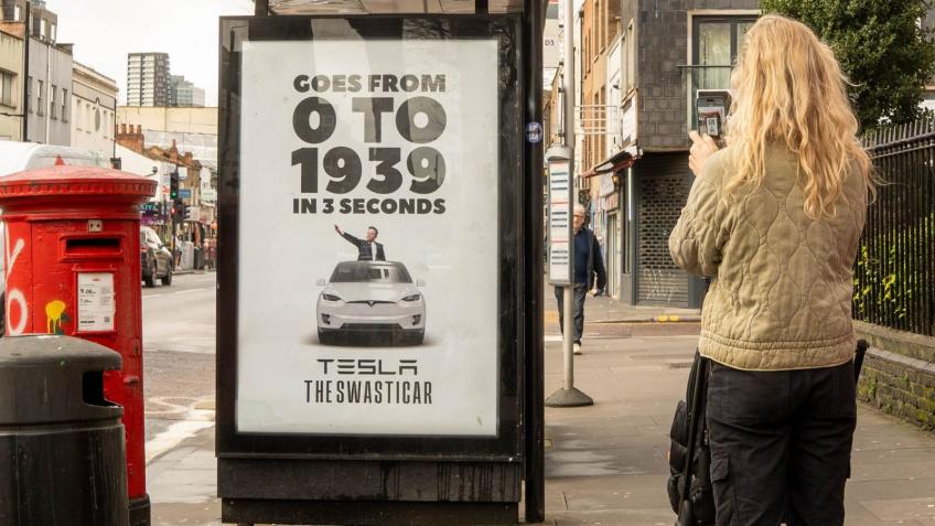 A poster at a London bus stop reading "0 to 1939" and featuring a graphic of the Tesla boss appearing to give a Nazi Salute