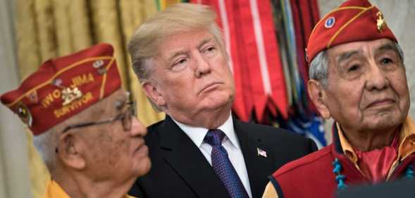 US President Donald Trump listens with Navajo Code Talkers in the Oval Office of the White House in November 2017.