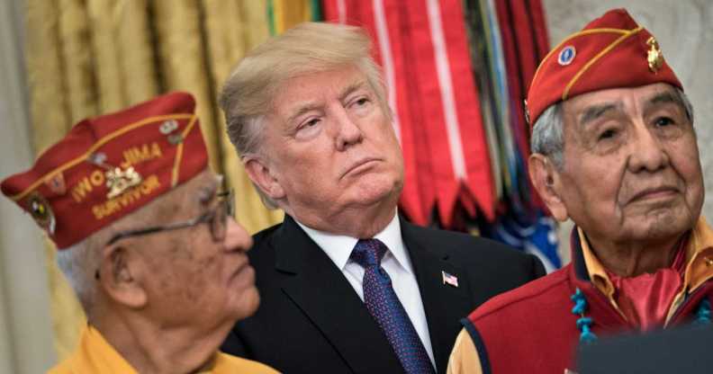 US President Donald Trump listens with Navajo Code Talkers in the Oval Office of the White House in November 2017.