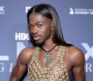 Lil Nas X poses on a red carpet in 2024.