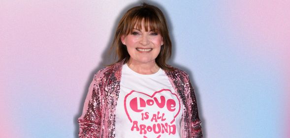 Lorraine Kelly smiling wearing a pink glittery coat and a 'love is all around' t-shirt, she is imposed against a pink and blue background.