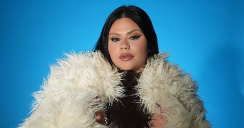 Malta's Eurovision entrant Miriana Conte in a white fur coat against a blue background.