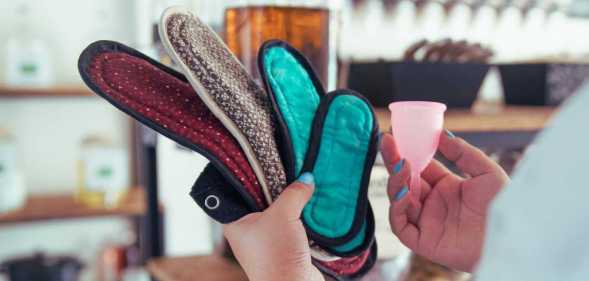 A woman holds sustainable period products.