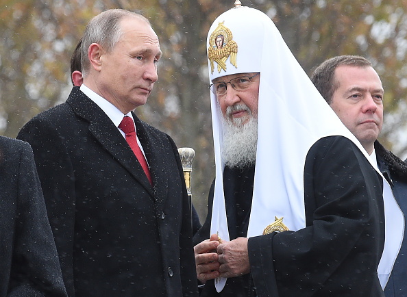 Russian President Vladimir Putin (L) speaks with Patriarch of Russia Kirill (R) as they attend the opening ceremony of the monument to Vladimir the Great in Moscow on November 4, 2016, as part of celebrations marking Russian National Unity Day. / AFP / SPUTNIK / Natalia KOLESNIKOVA (Photo credit should read NATALIA KOLESNIKOVA/AFP/Getty Images)