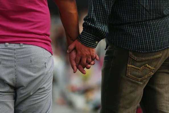 Getty; Gay couple holding hands.