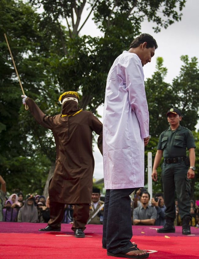 Men facing the cane in Indonesia